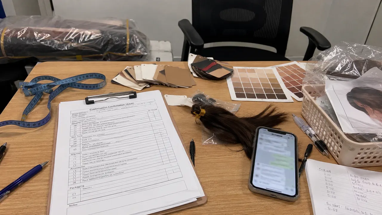 Phone photo of adult customization order checklist and covered samples